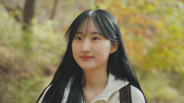 Young woman walking on colorful autumn trail