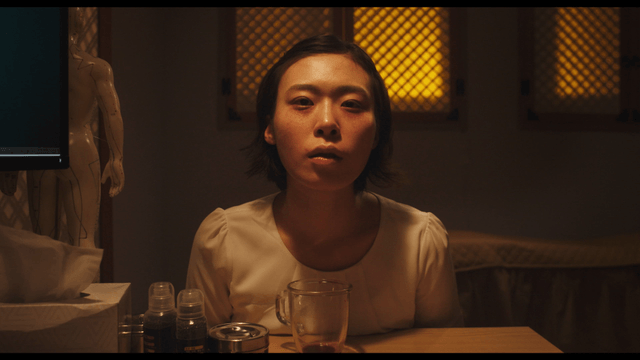 Female vampire drinking blood in glass at Korean medicine clinic