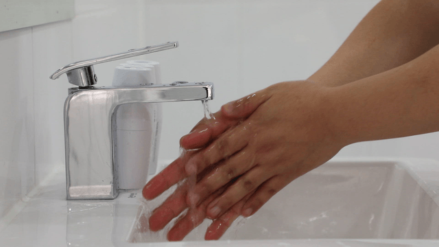 Hand washing with running water in a sink