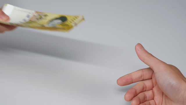 Hands exchanging currency bills