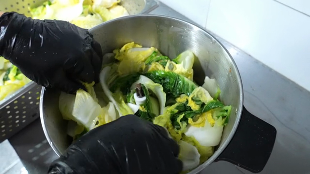 Napa cabbage being added to a blender