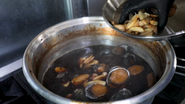 Mushrooms being added to a boiling pot