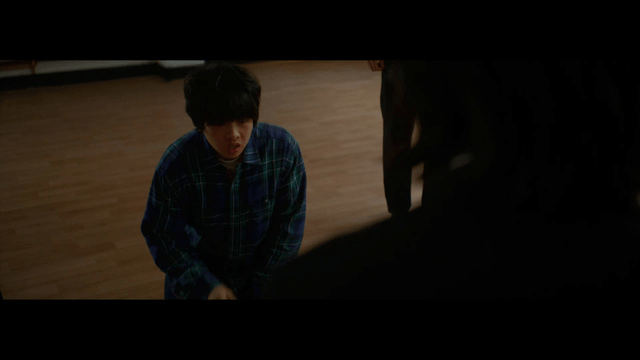 Young man kneeling on the floor indoors