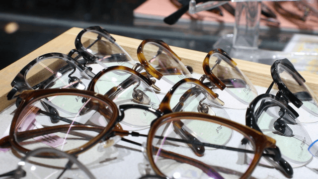 Various eyeglasses displayed on a tray