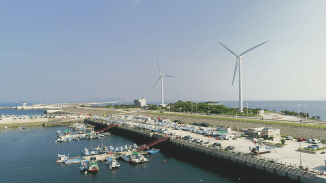 Wind turbines near a coastal harbor