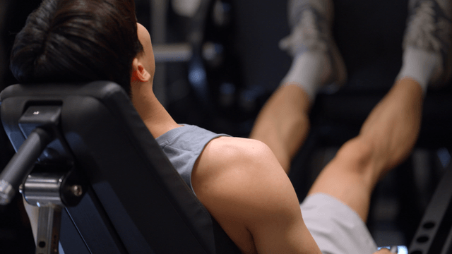 Man exercising on a leg press machine