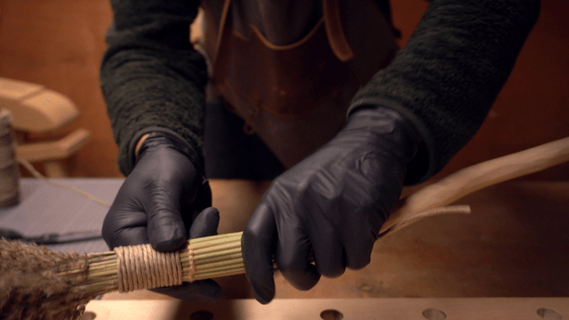 Person crafting a handmade broom