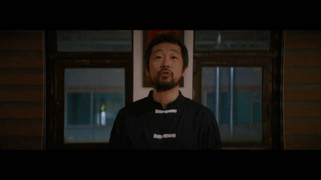 Man standing calmly in traditional Chinese clothing