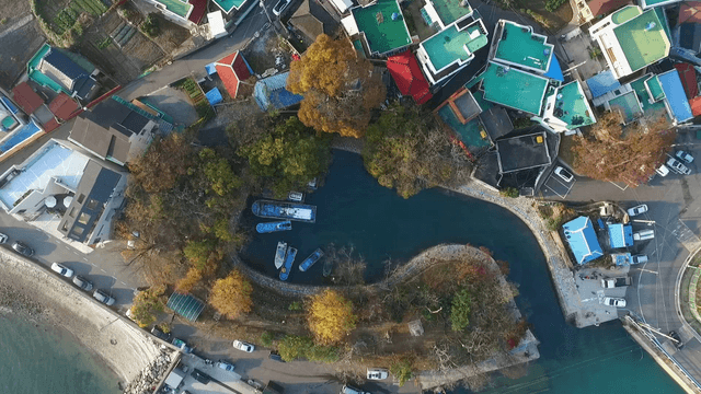 Aerial view of a coastal village with boats