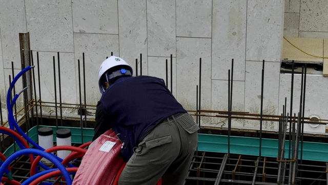 Workers handling cables at a construction site