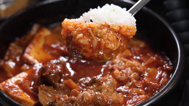 A spoonful of braised kimchi pork and rice