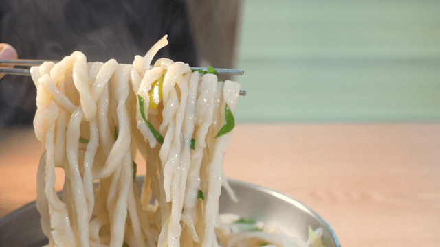 Hand-cut noodles served in a metal bowl