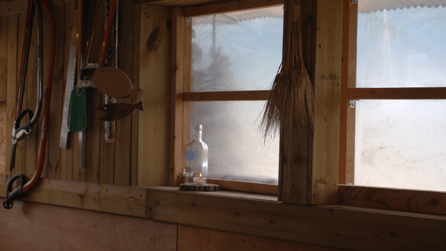 Cozy wooden workshop with tools and glass decorations