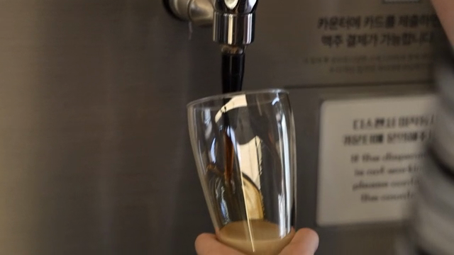 Dark beer being poured into a glass