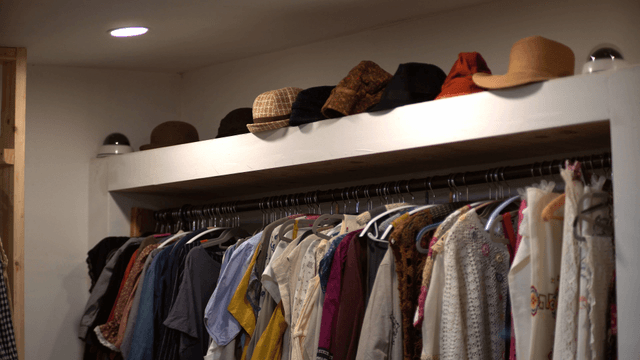 Clothes and hats displayed in a closet