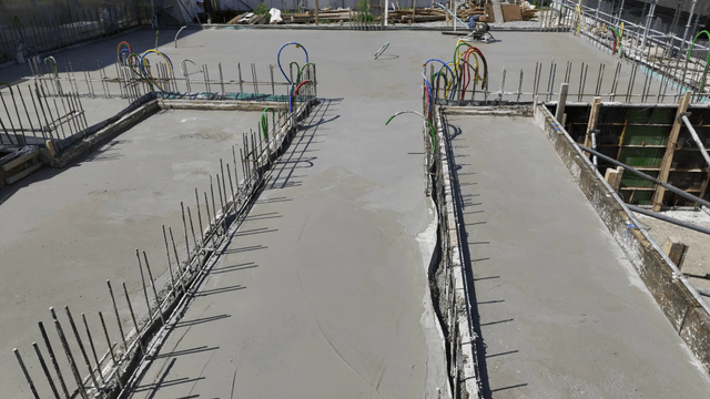 Concrete foundation with pipes and rebar