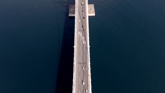 Bridge over the sea with city skyline