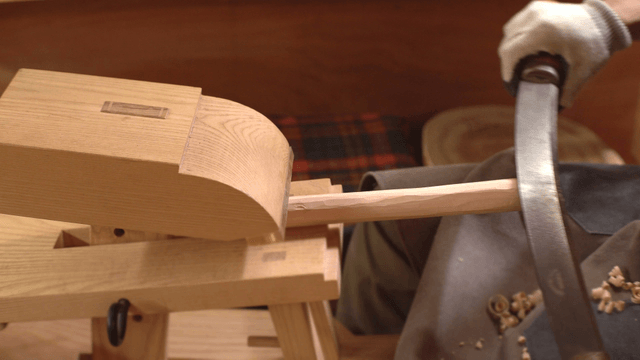 Woodworking with a hand tool indoors