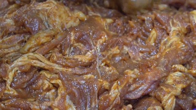 Marinated meat in a blue bowl