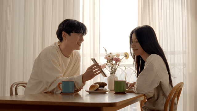 Couple taking photo of breakfast at table