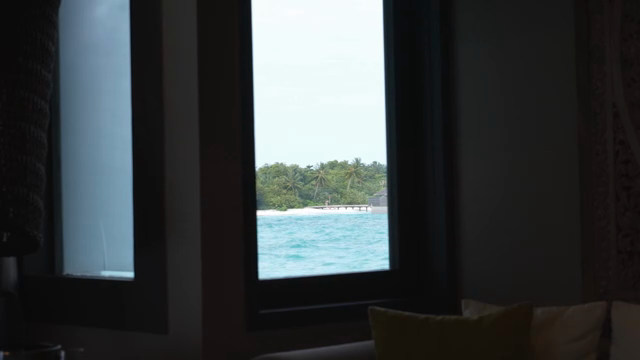 View of a tropical beach through a window