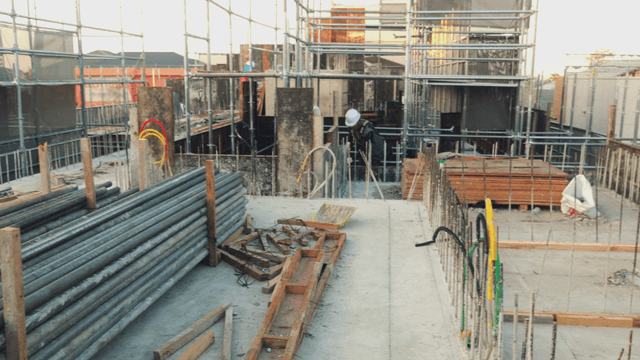 Construction site with steel materials and workers