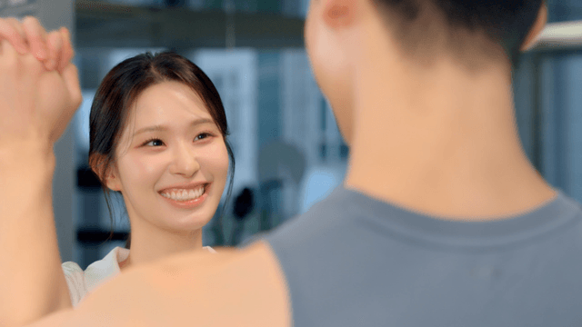 Couple encouraging each other while holding hands at gym