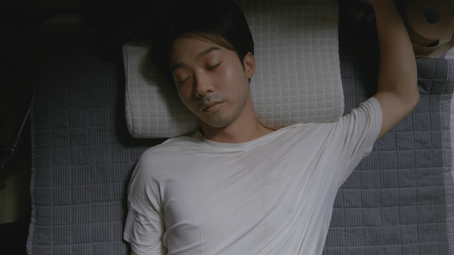 Man sleeping peacefully on a pillow