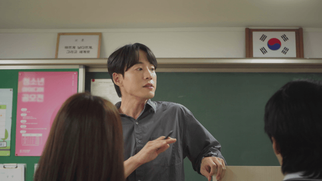 Teacher standing beside the podium and communicating with students