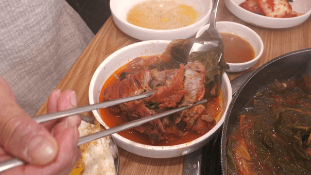 Outer leaves pork back-bone stew breaking apart with chopsticks