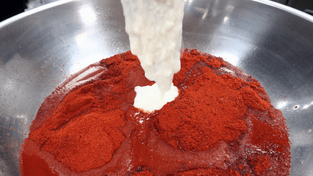 Grated yam mixed with chili powder in bowl