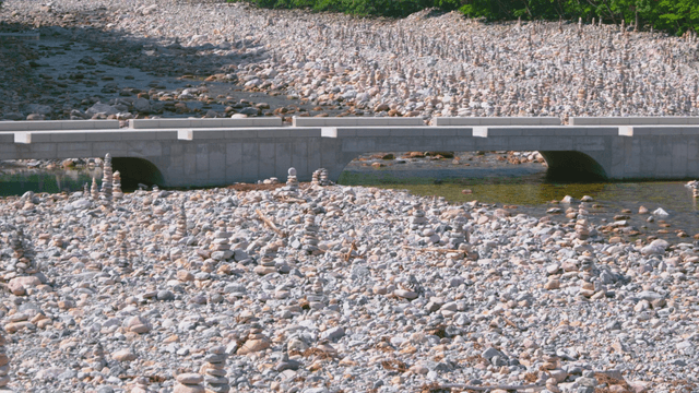 Stream with stone towers and neat bridge