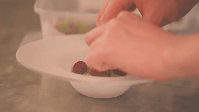 Gourmet dish topped with raspberries on avocado