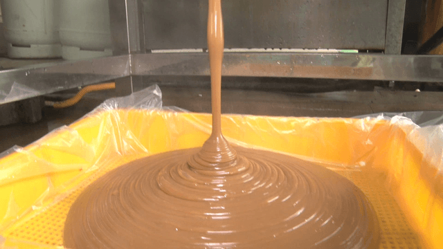 Acorn jelly coming out of a machine