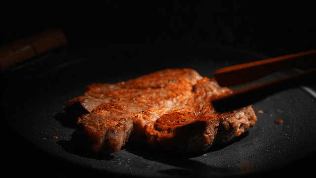 Steak being cooked on a pan