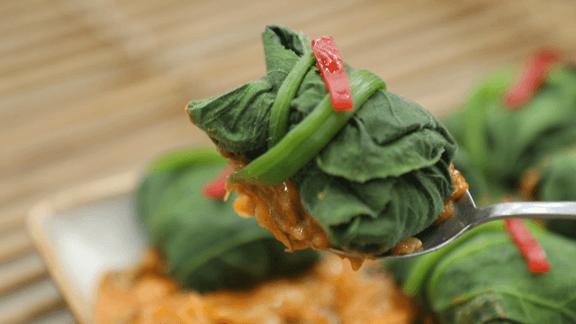 Spoon holding pumpkin leaf wraps with snail soybean paste