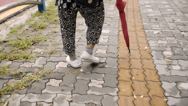 Person walking down the street with an umbrella