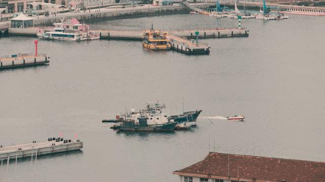 Fishing boats and pier in a busy harbor