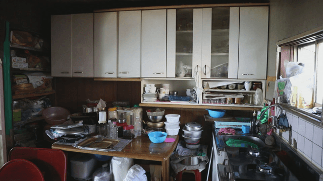 Cluttered kitchen with various utensils