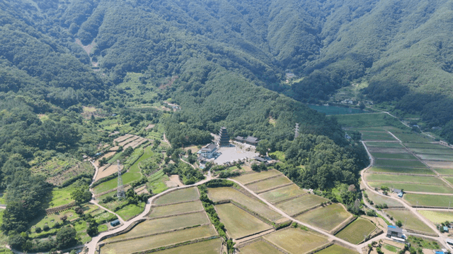 Mountain ridge landscape over farmland and temple