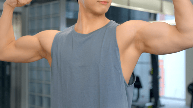 Man flexing muscles indoor