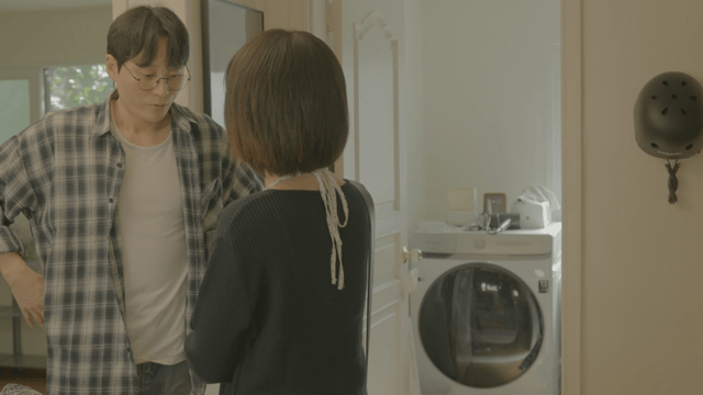 Man seeing woman off as she leaves home
