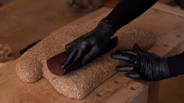 Artisan sanding a cork sculpture
