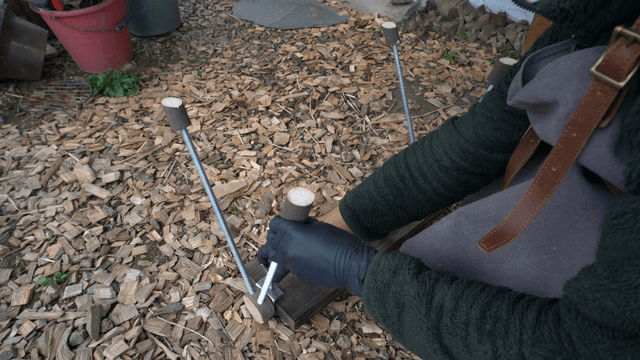 Artisan assembling a handmade wooden bench in outdoor workshop