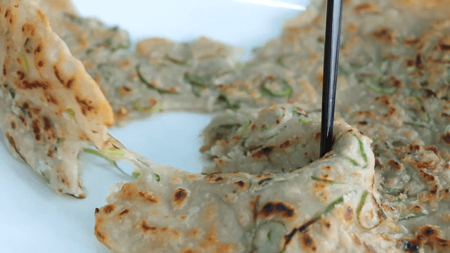 Cutting buckwheat pancake with chopsticks