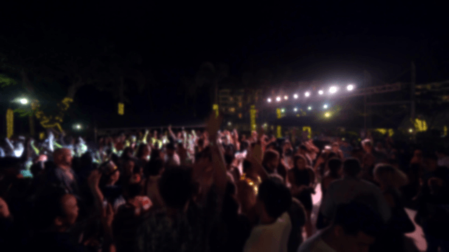 Nighttime outdoor party with a lively crowd