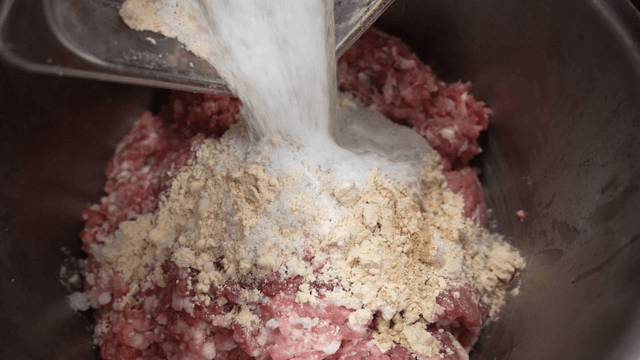 Spices poured onto minced meat