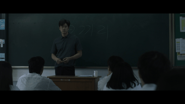 Teacher giving lesson to students in classroom