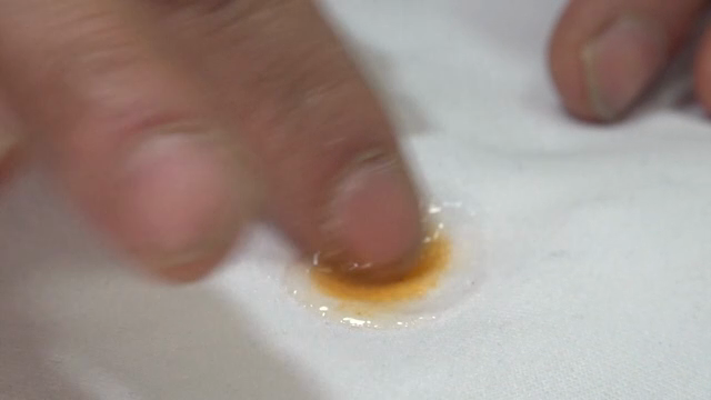 Cleaning a stain on white fabric