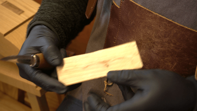 Artisan carving wood precisely with a knife